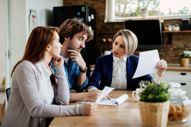 financial advisor communicating with young couple while going through their financial reports during meeting home 637285 3046 KJ Conroy & Co. Solicitors